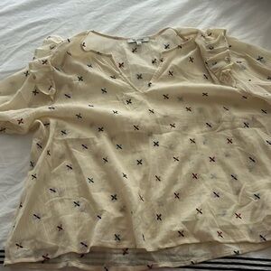 Madewell top with multi colored embroidered details.